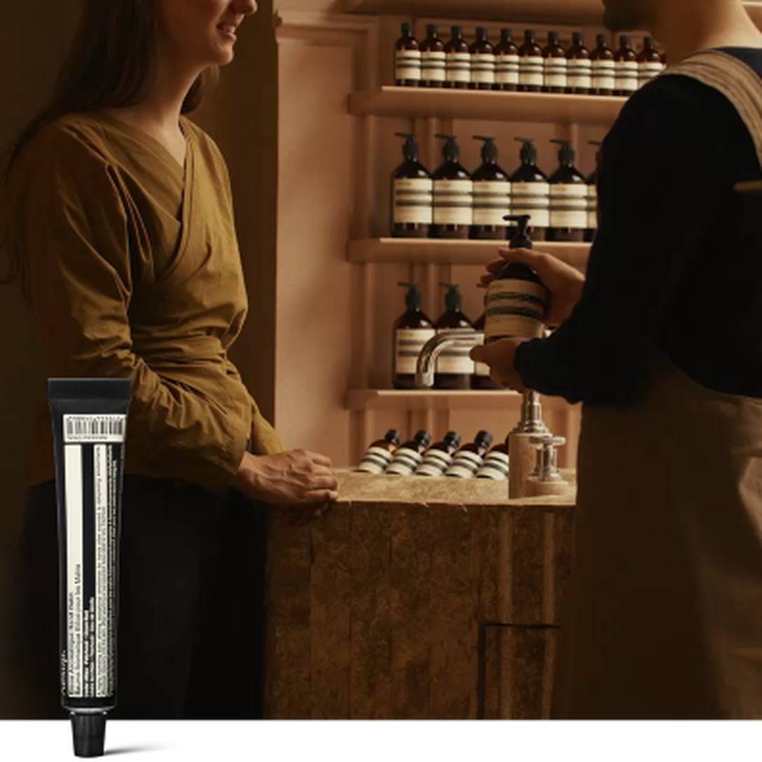 A hand care consultation in an Aesop store, beside a complimentary 15mL Eleos Aromatique Hand Balm offered upon email subscription.